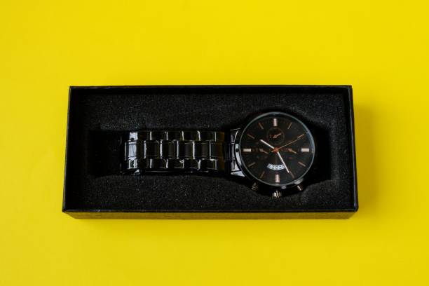 istock watch, with black cardboard isolated on yellow background 1403975396