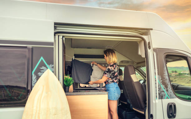 istock Woman hanging out the laundry inside her camper van 1403975585