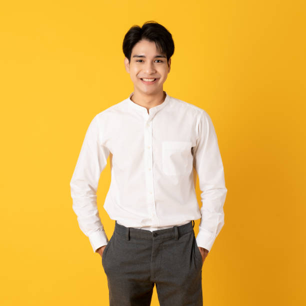 istock Good looking teenage asian man with smile isolate on yellow background 1403976305