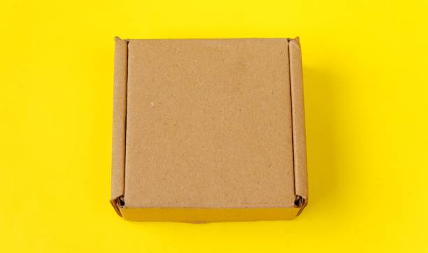 istock Cardboard isolated on a yellow background 1403976484