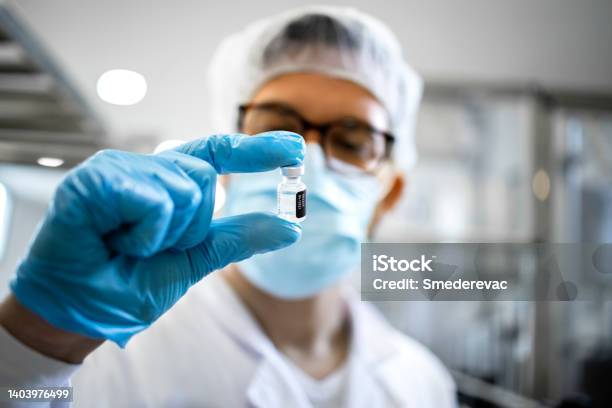 Pharmaceutical Worker Or Technologist In Protective Equipment Controlling Quality Of Vaccine Production In Factory Stock Photo - Download Image Now