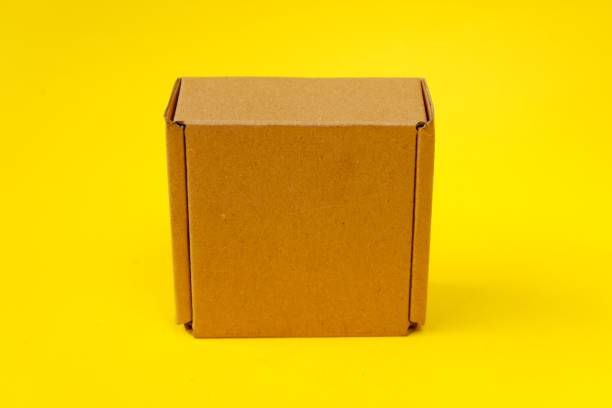 istock Cardboard isolated on a yellow background 1403976546