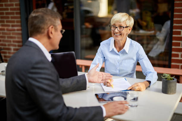 istock Mature business people collaborating after work in coffee shop 1403976720