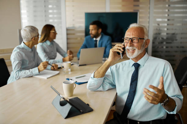 istock Senior businessman using mobile phone in the office 1403976884