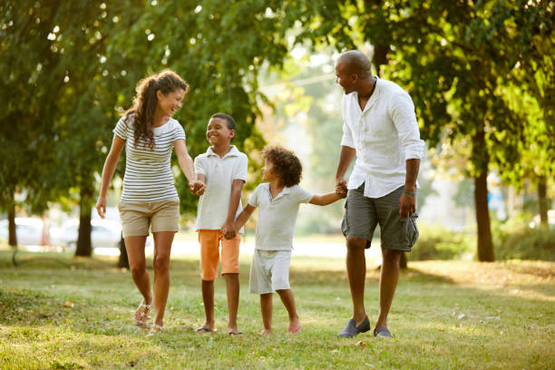 istock Happy couple spending time with their sons in the park 1403977475