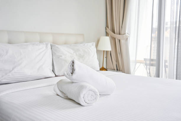 istock rolled up white towels on the hotel bed 1403979436