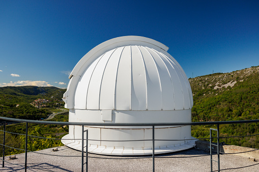 Rijeka, Croatia April 27 2022: Rijeka Observatory, part of Astronomical Centre, white dome on a hill closed at daytime, clear sky above