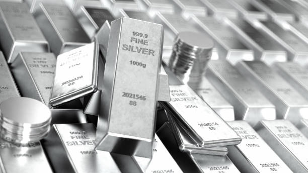 Stack of Shiny Silver Bars Ingots and Coins stock photo