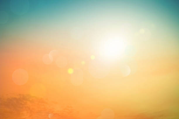 Relaxing outdoors vacation landscape concept: Abstract blurred sunlight beach colorful blurred bokeh background with retro effect autumn sunset sky have blue bright, white, and color orange calm.