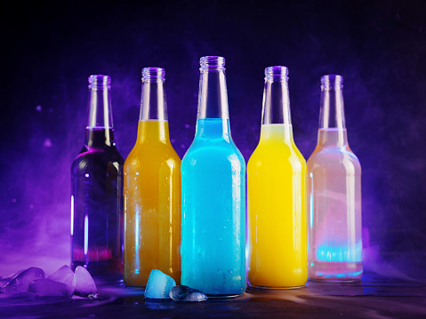 Picture of pyramid line of burning alcohol cocktails standing on a bar counter with copy-space