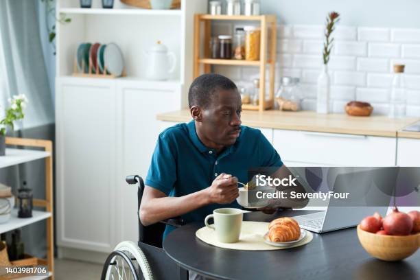 African American Man with Disability at Breakfast