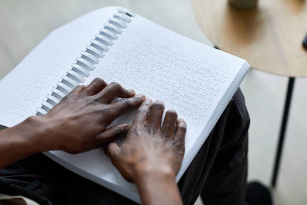 istock Man Reading Book in Braille Closeup 1403981808