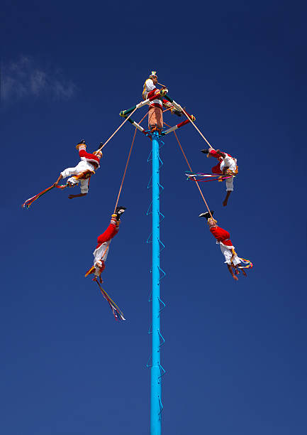The Flying High Flyers Mexican flyers from Vera Cruz perform a part of a traditional sun worship ritual volador stock pictures, royalty-free photos & images