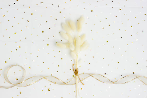 istock White natural flowers with ribbon over the white background. 1403984341
