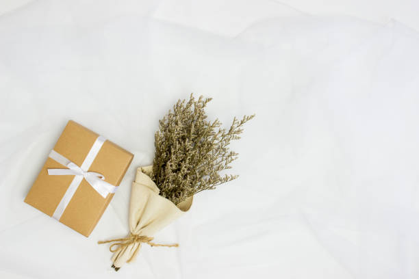 istock A brown craft box with natural white bouquet over the white background. 1403984343