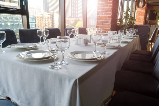 istock Table set with empty glasses, white plates in a restaurant 1403985500