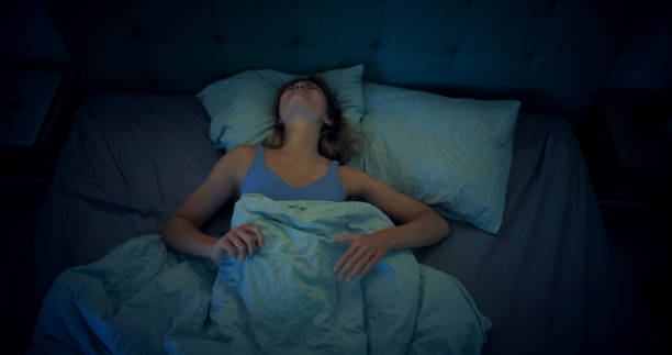 istock Woman in bed can't sleep due to insomnia 1403985749