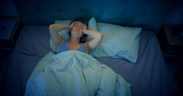 istock Woman in bed can't sleep due to insomnia 1403985790