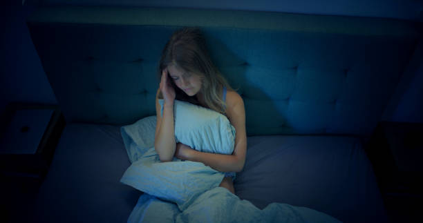 istock Woman in bed can't sleep due to insomnia 1403985797