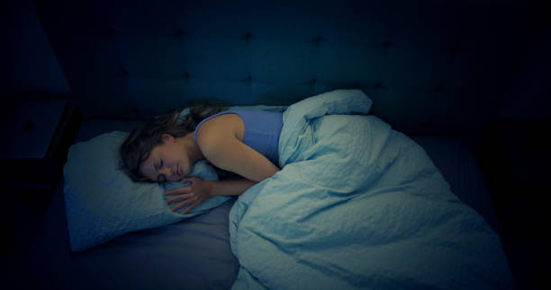 istock Woman in bed can't sleep due to insomnia 1403985800