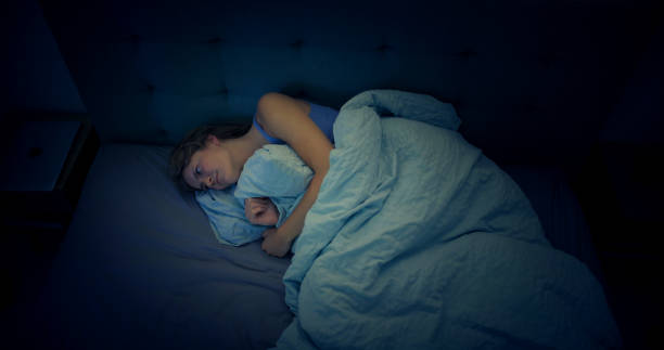 istock Woman in bed can't sleep due to insomnia 1403985820
