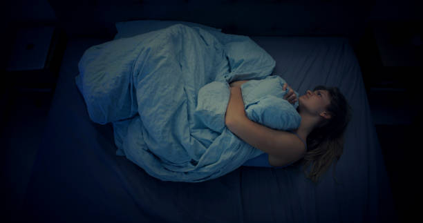 istock Woman in bed can't sleep due to insomnia. High angle view 1403985825