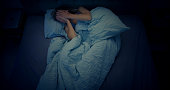 Woman in bed can't sleep due to insomnia