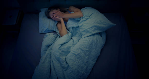 istock Woman in bed can't sleep due to insomnia 1403985847