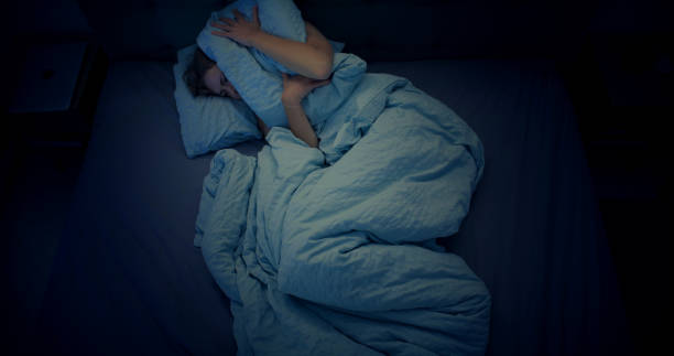 istock Woman in bed can't sleep due to insomnia 1403985859