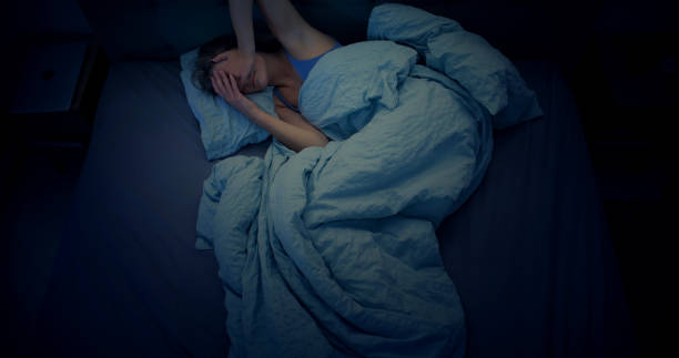 istock Woman in bed can't sleep due to insomnia 1403985869
