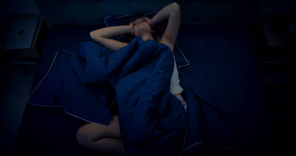 istock Woman in bed can't sleep due to insomnia 1403985876