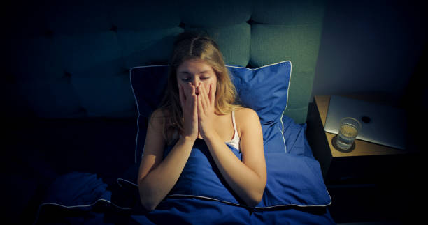 istock Woman in bed can't sleep due to insomnia 1403985929