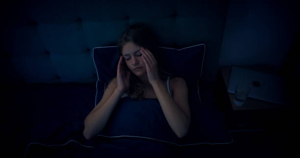 istock Woman in bed can't sleep due to insomnia 1403985930