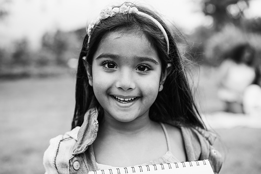 Portrait of indian female kid outdoor - Focus on eyes - Black and white edition
