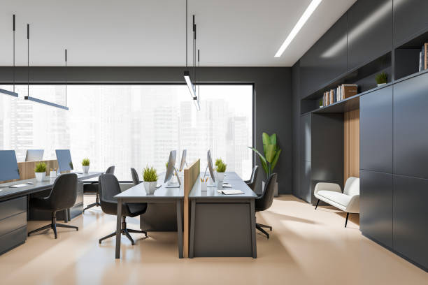 istock Side view on dark office interior with tables with desktops 1403987763