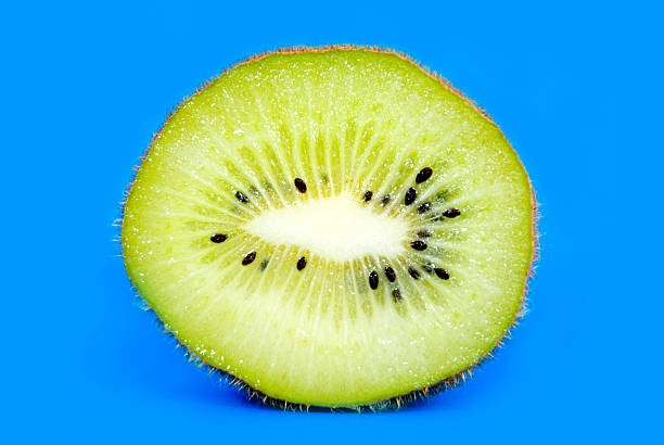 istock Slice of kiwi on blue background 140398864
