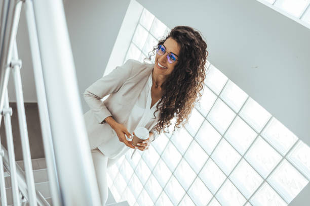 istock Female professional is holding disposable cup 1403989316