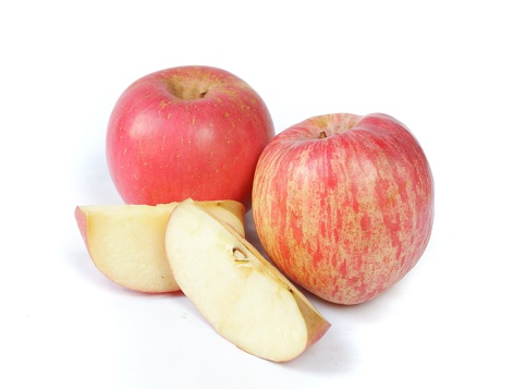fresh fuji apple with slices isolated on white background