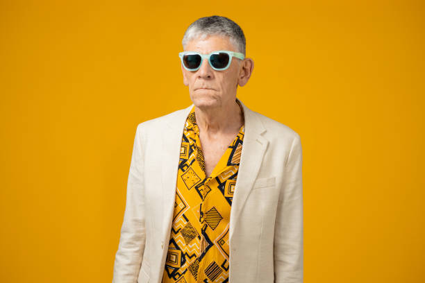 istock Cool senior man against yellow background 1403989783