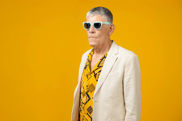 istock Cool senior man against yellow background 1403989785