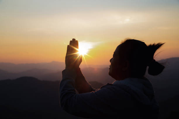 istock woman worship on sunset 1403989882