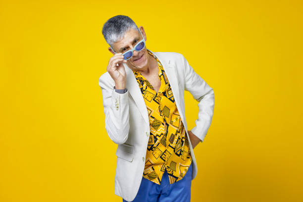 istock Youthful senior man against yellow background 1403990018