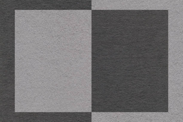 istock Texture of black and gray paper background with geometric pattern, macro. Structure of craft graphite cardboard 1403990047