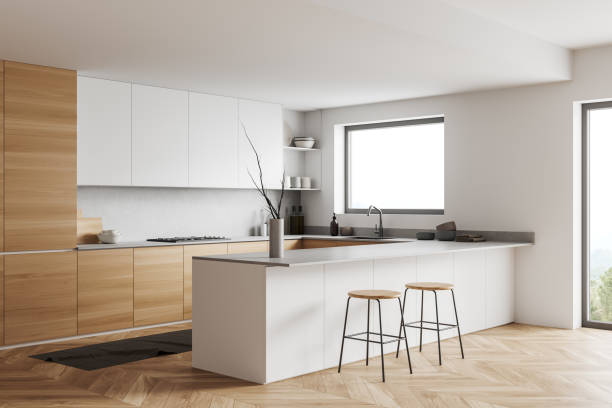 istock Light kitchen interior with island and seats, shelves and kitchenware, window 1403990758
