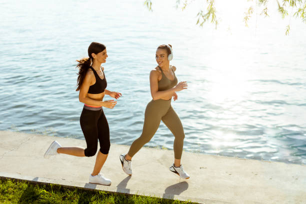 istock Young woman taking running exercise by the river promenade 1403990864