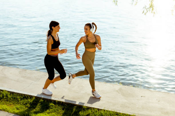 istock Young woman taking running exercise by the river promenade 1403990867