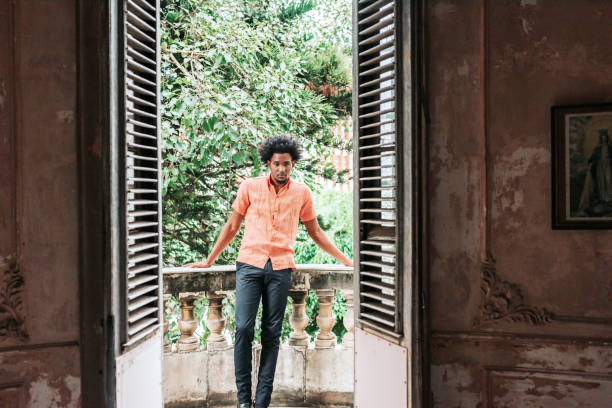 istock man leaning at balcony balustrade in havana 1403991206