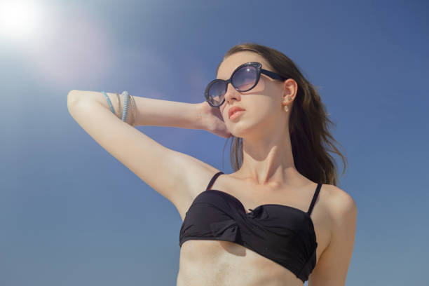 istock young woman tanning 1403991480