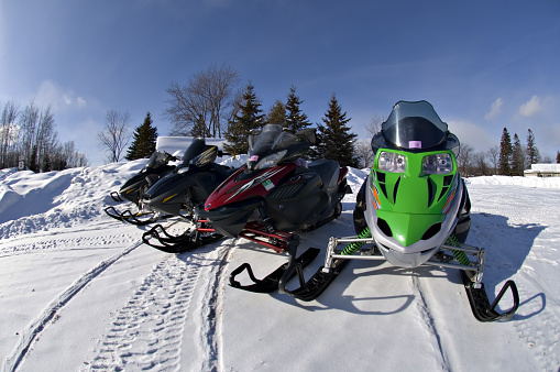 Four snow mobiles in a line in the Upper Michigan