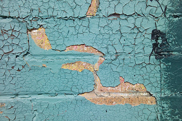 Brick Wall with Cracking Turquoise Paint stock photo